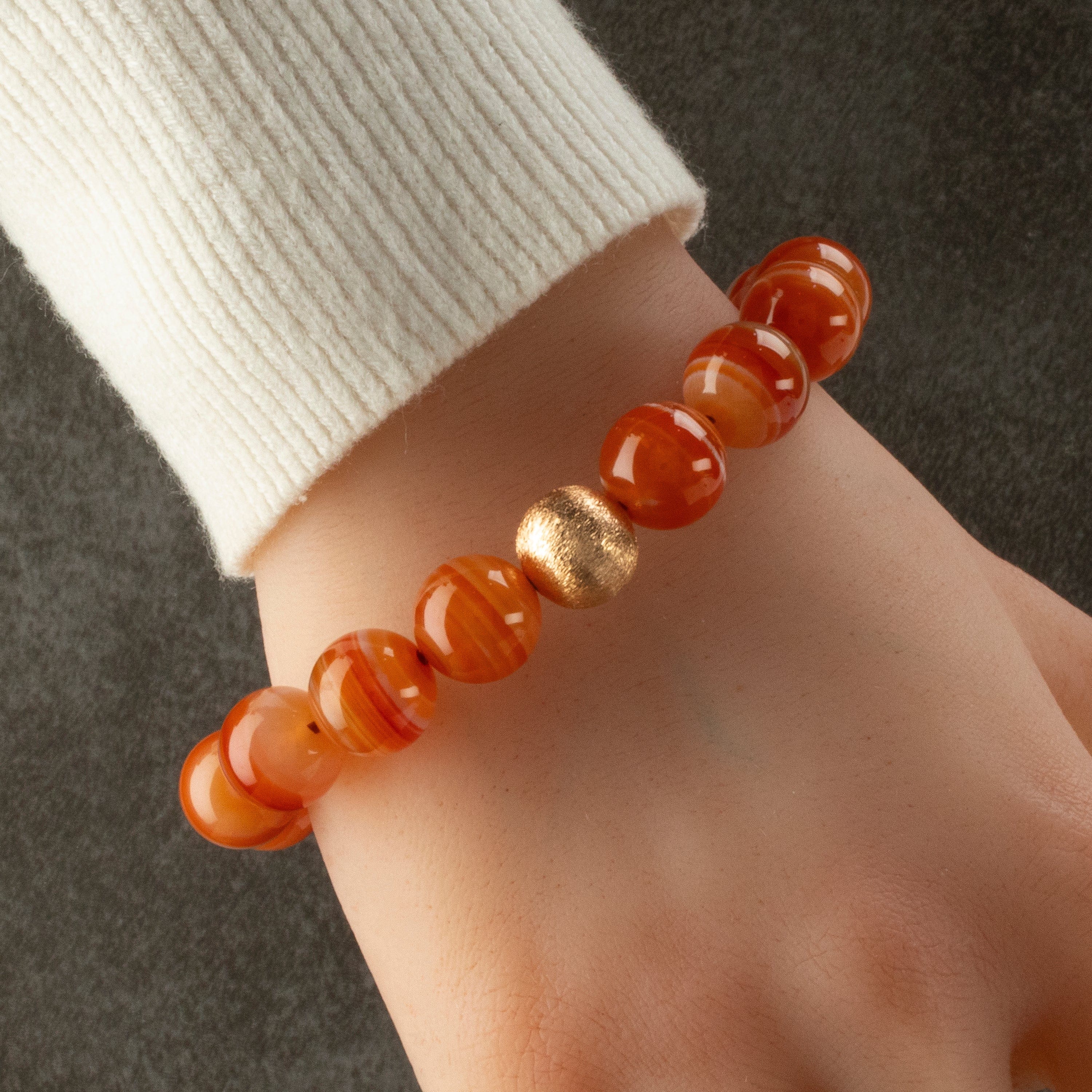 Kalifano Gemstone Bracelets Polished Banded Carnelian 12mm Gemstone Bead Elastic Bracelet with Matte Gold Accent Bead GOLD-BGP-073